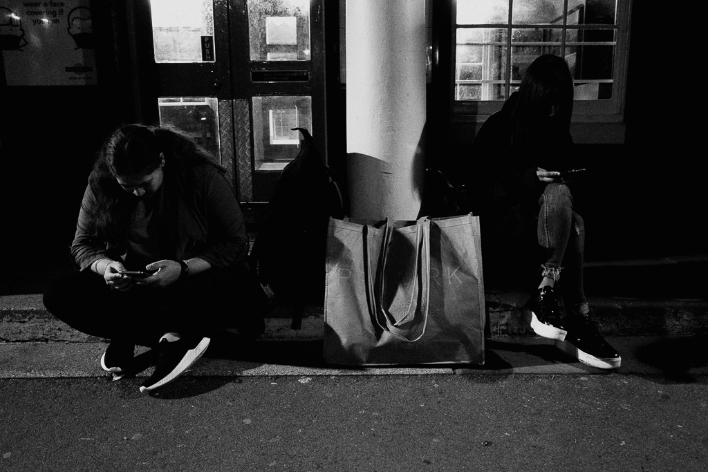 Two girl waiting at night on train station